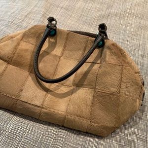 Camel pony fur On one side the other side is a brown and beige Fabric